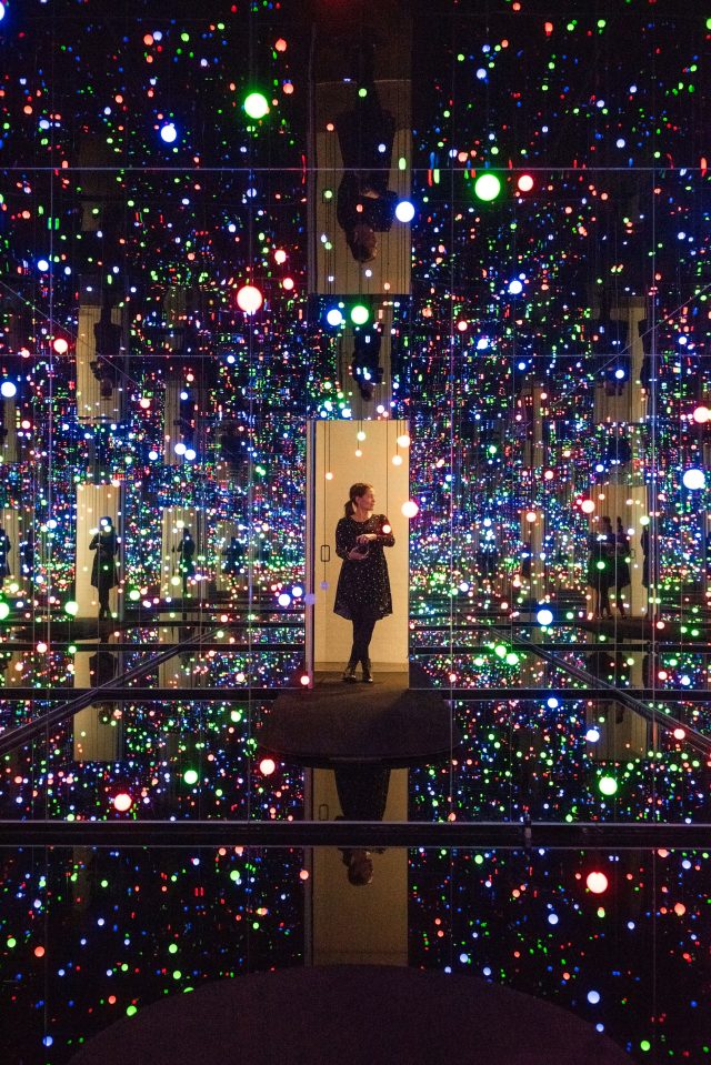 Colored lights reflected in Yayoi Kusama’s Gleaming Lights of the Souls installation